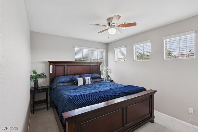 Bedroom featuring light carpet, baseboards, and a ceiling fan | Image 42