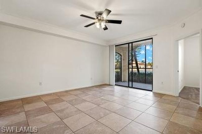 Spare room with light tile patterned floors, baseboards, and ceiling fan | Image 6