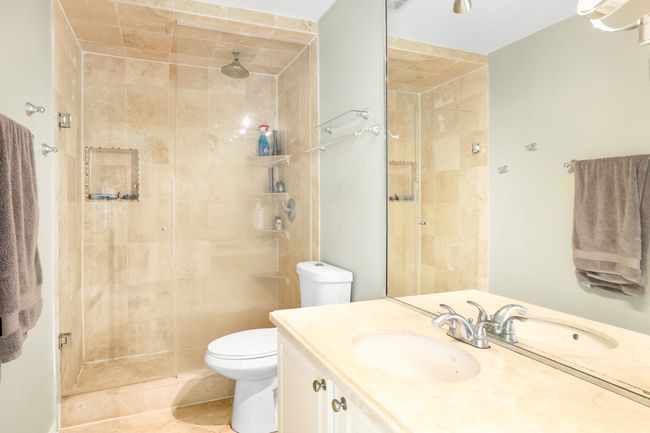 Full bath featuring a stall shower, vanity, toilet, and tile patterned floors | Image 12