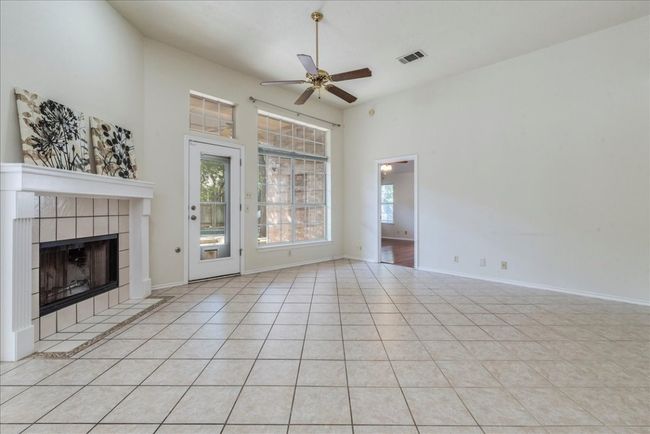 Family room with door leading out to patio and pool | Image 15