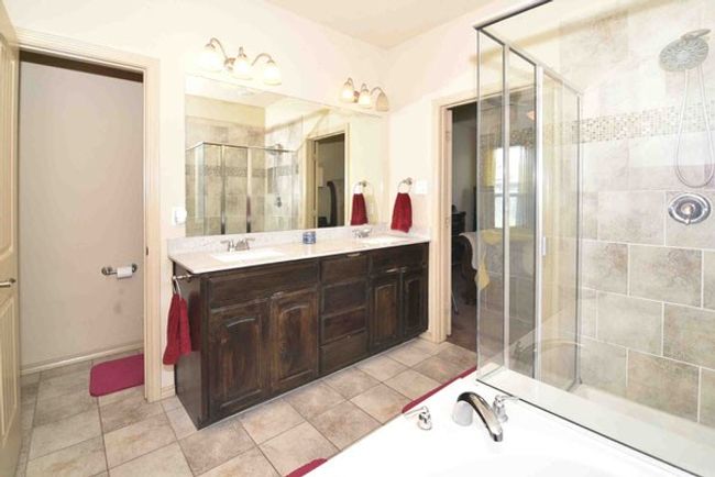 Bathroom with a shower stall, double vanity, a tub to relax in, and tile patterned flooring | Image 21