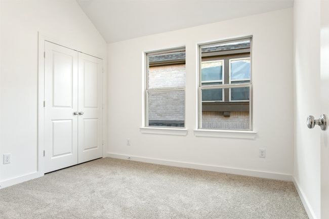 Unfurnished bedroom with light carpet, vaulted ceiling, and a closet | Image 33