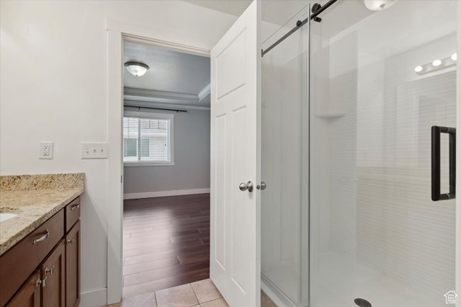 Full bath with baseboards, vanity, a stall shower, and crown molding | Image 19