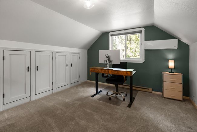 Carpeted home office with vaulted ceiling and baseboards | Image 27