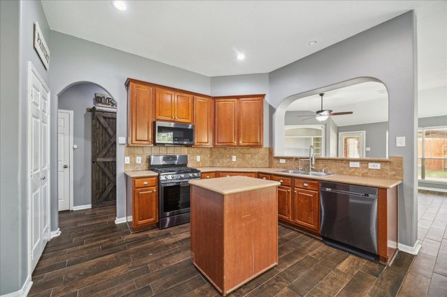 Ample counter space with a rolling island for your convenience | Image 15