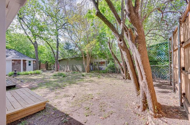 View of yard featuring a wooden deck and an outbuilding | Image 17