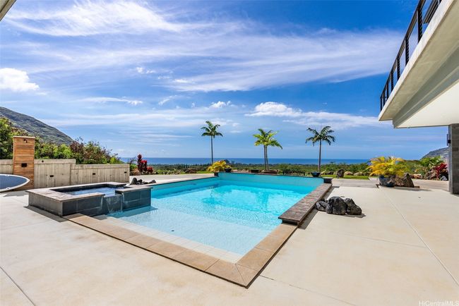 Pool with integrated hot tub, out door shower, and covered deck space. Expansive views of the ocean, and walking path that leads to the lower 1 acre lot with plenty of grass and space. | Image 6
