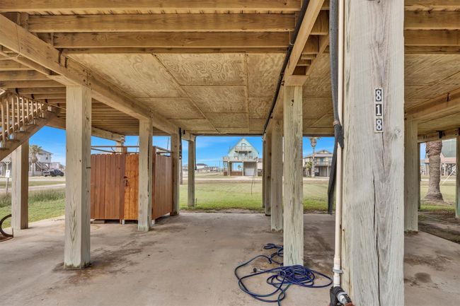 Concrete surface below the house offers space for parking multiple vehicles and water toys. | Image 20
