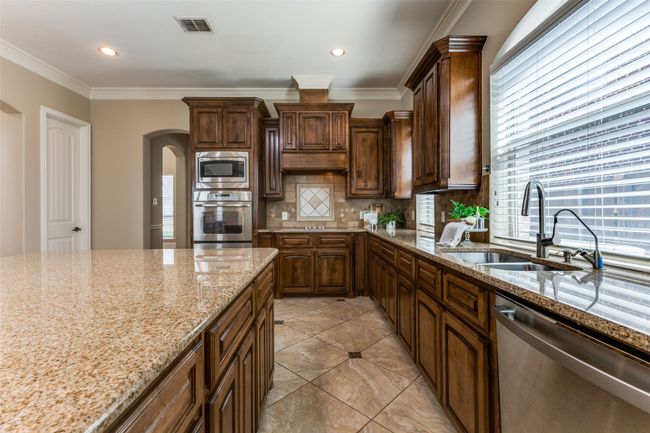 The kitchen also features an electric cooktop, and the kitchen is also plumbed for gas. | Image 11