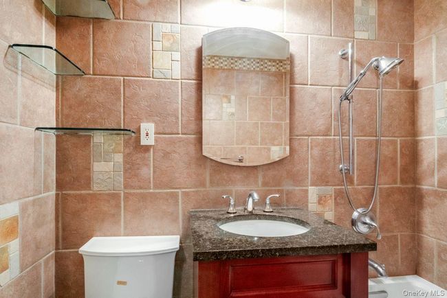 Full bath featuring toilet, vanity, and shower / bathtub combination | Image 14