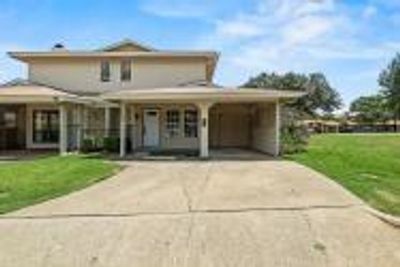 View of front of home with a carport and a front yard | Image 1