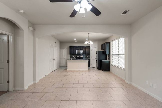 View of combined living room, dining area, and kitchen. | Image 11