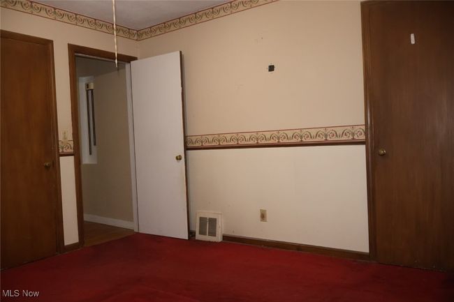 Unfurnished bedroom with baseboards and visible vents | Image 9