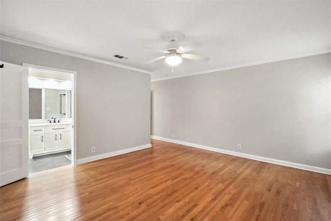 Living area with ornamental molding, wood finished floors, and french doors | Image 15