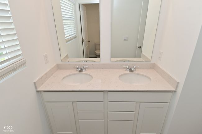 bathroom featuring healthy amount of natural light and double vanity | Image 43