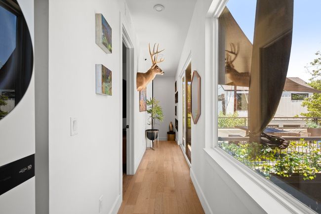 Hallway featuring light wood finished floors and baseboards | Image 18