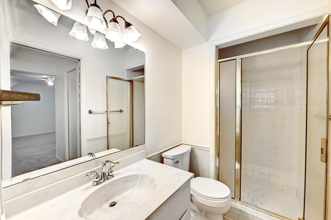 Bathroom featuring toilet, a stall shower, and vanity | Image 20