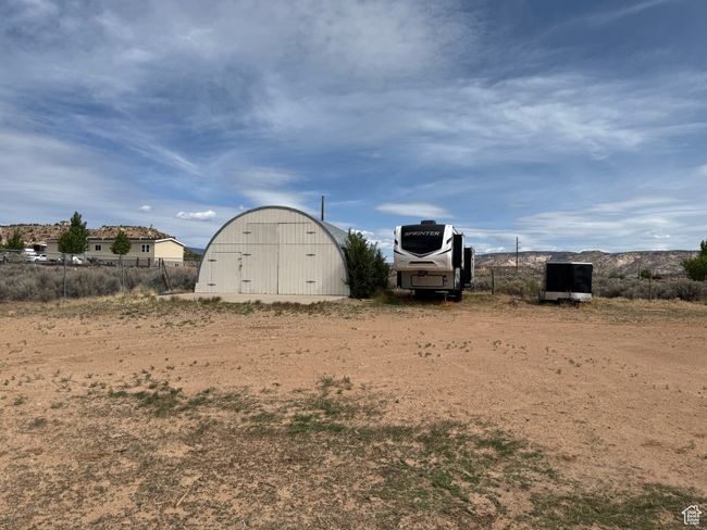 View of yard featuring an outdoor structure and a pole building | Image 21