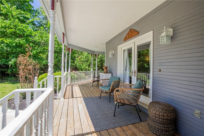 French door from main level living room open to up to front porch. | Image 7