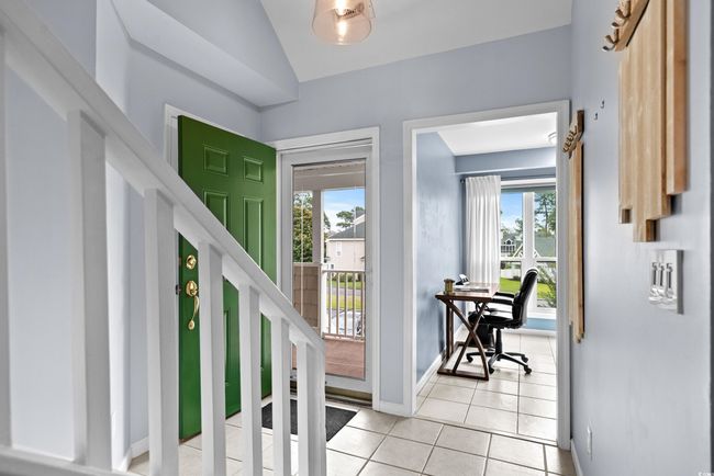 Foyer with light tile patterned floors, baseboards, plenty of natural light, and vaulted ceiling | Image 5