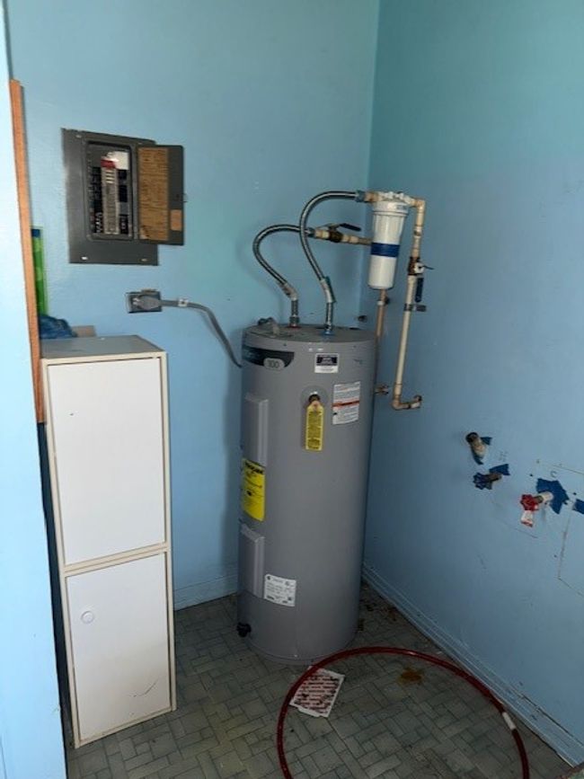 Utility room with water heater and electric panel | Image 11