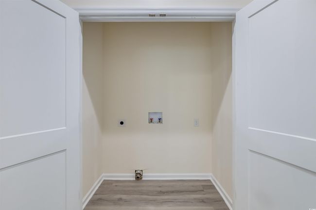 Washroom featuring hookup for an electric dryer, washer hookup, light wood-style floors, and baseboards | Image 15