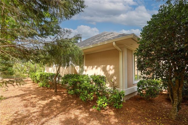 Beautiful landscaping surrounds the home. | Image 51