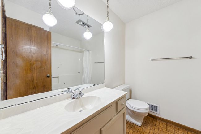 Main level full bathroom with a large vanity providing ample storage | Image 14