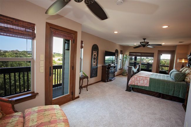 Bedroom featuring access to outside, light colored carpet, recessed lighting, and a ceiling fan | Image 13