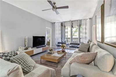 Living room featuring ceiling fan and hardwood / wood-style flooring | Image 1