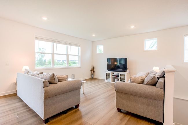 Cozy living area with abundant natural light, multiple windows, and space to unwind or host. | Image 13