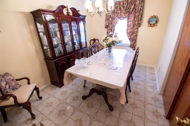 Dining room featuring baseboards and a notable chandelier | Image 13