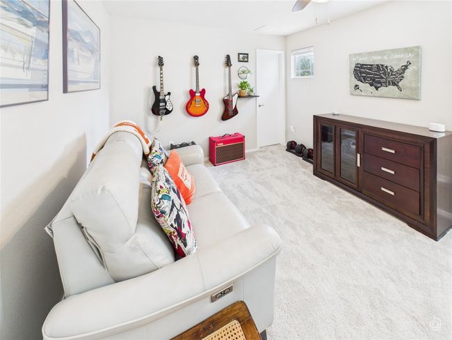 Carpeted living area with ceiling fan | Image 23