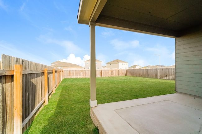 Fenced backyard with a patio | Image 24