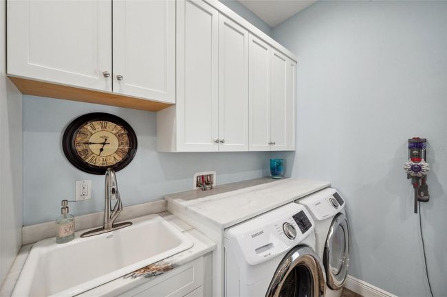 Laundry/pantry room on 2nd floor includes more custom solid wood cabinets and stone counter. And a large cast iron laundry sink. | Image 41