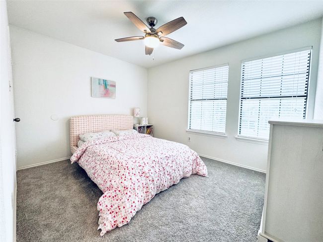 Bedroom featuring carpet floors, baseboards, and ceiling fan | Image 22