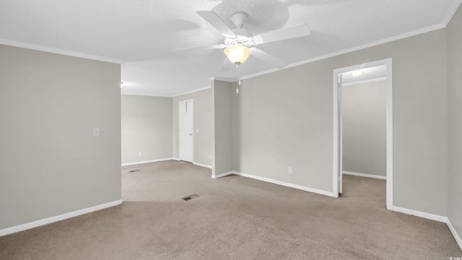 Carpeted spare room featuring a ceiling fan and ornamental molding | Image 16