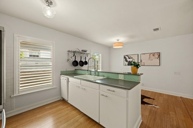 A breakfast bar separates the kitchen from the dining for casual eating and serving/entertaining. | Image 9