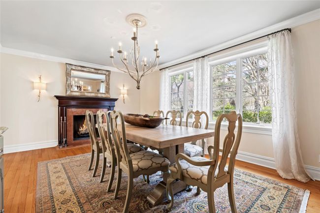 Dining room features a wood burning fireplace | Image 7