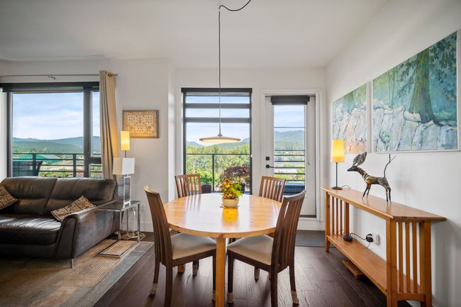 Dining room with dark wood finished floors and a mountain view | Image 7