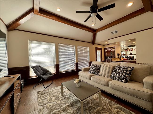 Living room featuring a wainscoted wall, a ceiling fan, and wood finished floors | Image 17