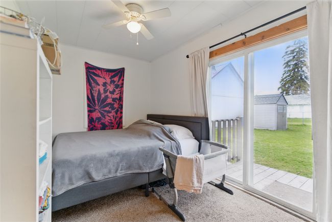 Bedroom featuring access to exterior, carpet flooring, and ceiling fan | Image 20