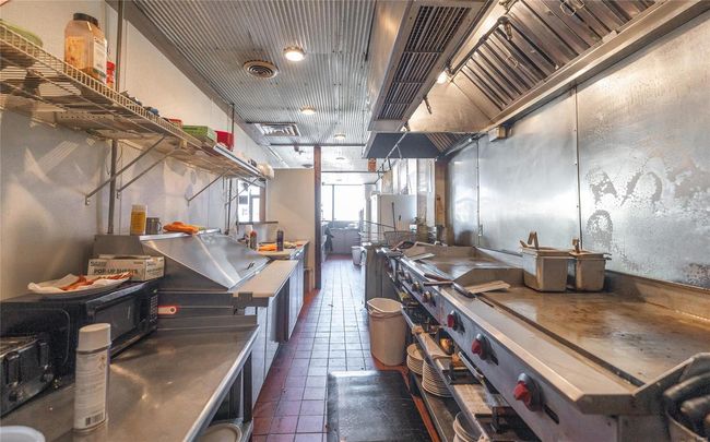 Kitchen with dark tile patterned flooring | Image 16