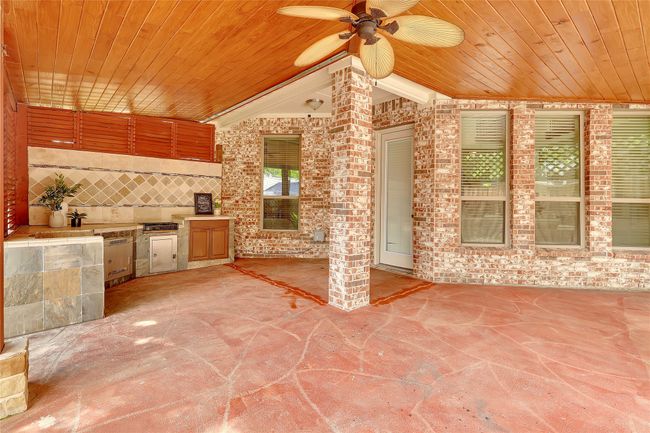 View of patio with a ceiling fan and an outdoor kitchen | Image 37