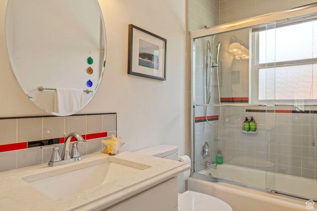 Bathroom featuring shower / bath combination with glass door and vanity | Image 15