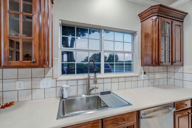 Stainless appliances, custom hardwood cabinets, and farm sink complete your amazing kitchen. | Image 20