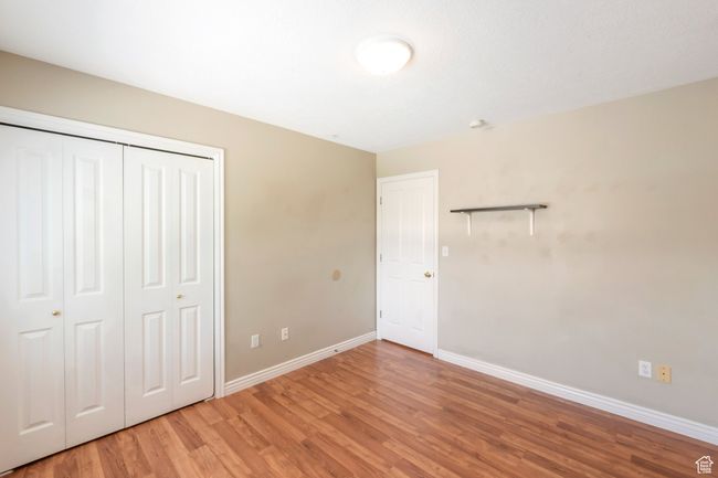 Unfurnished bedroom featuring light wood-type flooring and a closet | Image 14