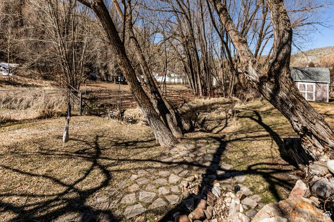 View of yard with an outbuilding and fence | Image 31