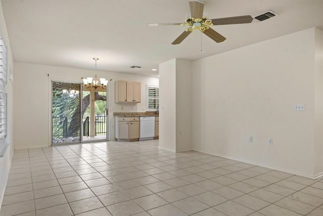Living room featuring a chandelier, ceiling fan, and light tile patterned floors | Image 7