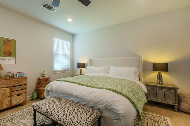 Bedroom featuring light wood-style flooring, ceiling fan, and recessed lighting | Image 15